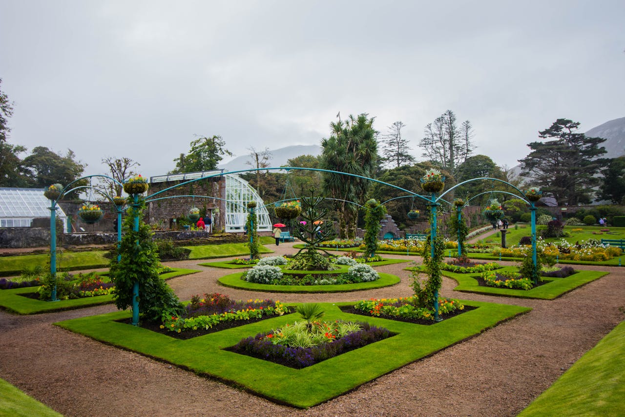 Explore a meticulously designed garden in Ireland featuring vibrant flowers and lush greenery.