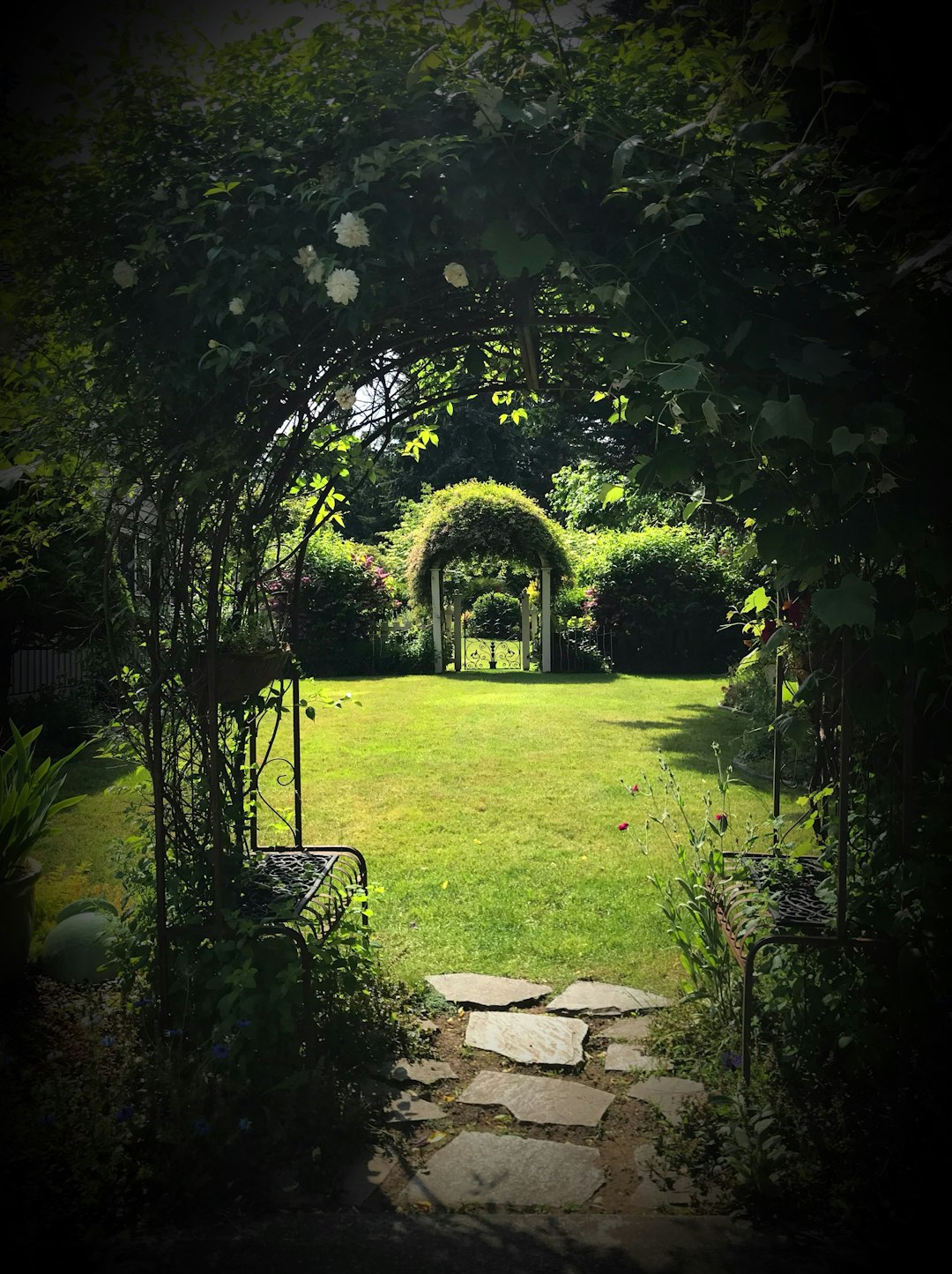 This is a private garden of a friend of mine who lives in Western Washington. She has been working on her yard for 27 years. The second archway leads to a third.